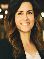 Smiling woman with long hair, professional setting.