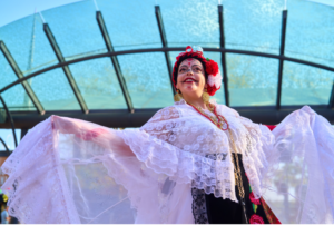 Woman in traditional dress dancing with shawl