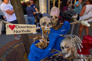 Skeletons holding 'I ❤️ Downtown Northville' sign